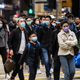 Pedestrians wearing face masks cross a road during a Lunar New Year of the Rat public holiday in Hong Kong on January 27, 2020, as a preventative measure following a coronavirus outbreak which began in the Chinese city of Wuhan.